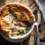 Top-down view of a freshly baked homemade chicken pot pie kentucky fried style with a flaky golden crust.