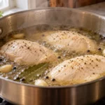 How long to boil chicken breast – sliced poached breasts on a cutting board